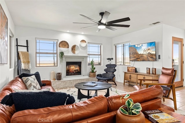 tiled living room with ceiling fan