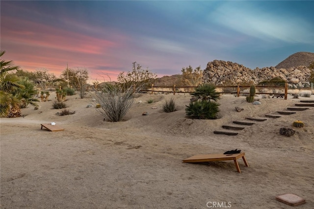 yard at dusk featuring a mountain view