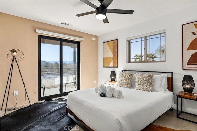 bedroom featuring ceiling fan, access to outside, and multiple windows