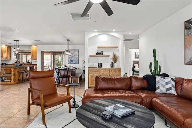 tiled living room with ceiling fan