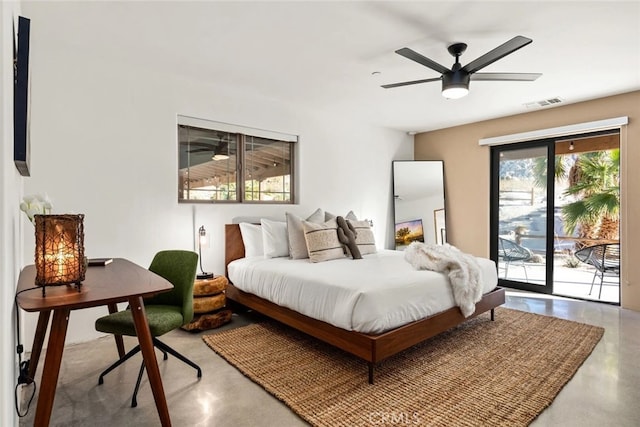 bedroom featuring ceiling fan, concrete flooring, and access to exterior