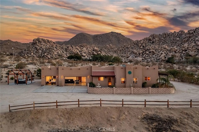 back house at dusk featuring a mountain view