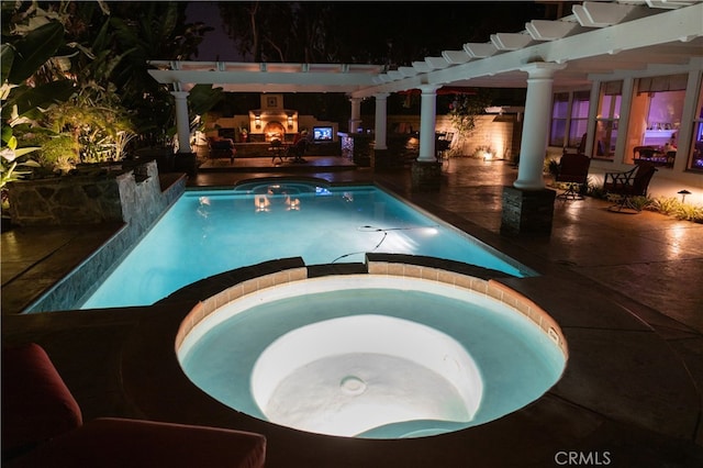 2221 Ventia, Tustin, CA 92782 - pool at night with a pool with connected hot tub, a patio area, and a pergola