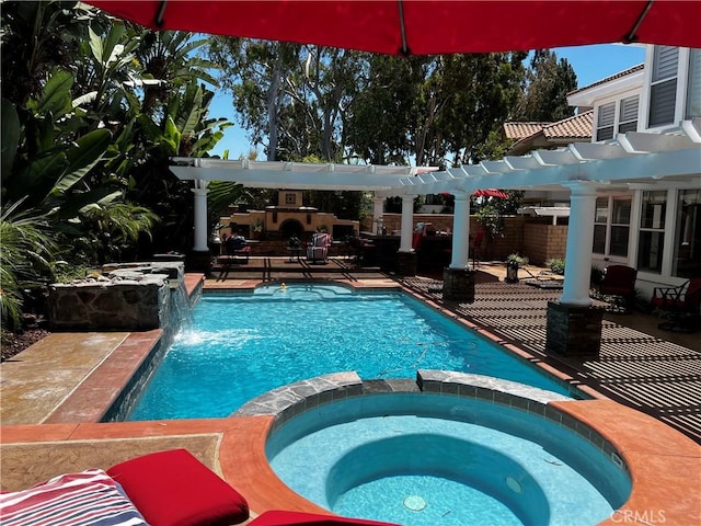 view of pool with an in ground hot tub, a pergola, pool water feature, and a patio area