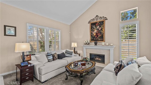 living room featuring carpet floors and high vaulted ceiling