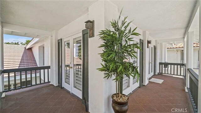 balcony with covered porch and french doors