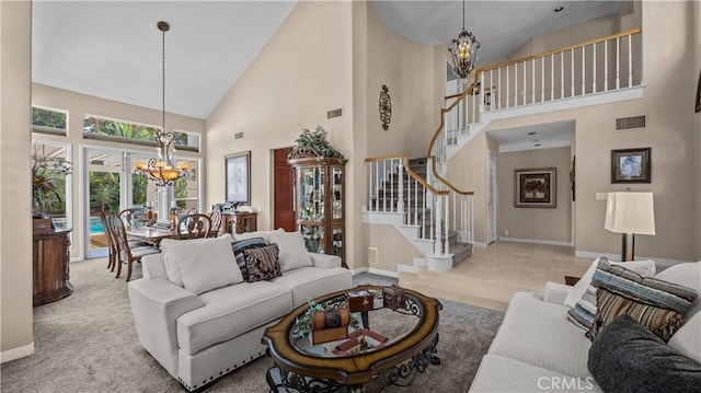 tiled living room with high vaulted ceiling and an inviting chandelier