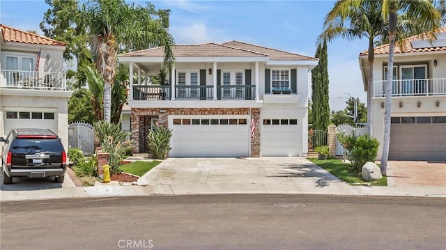 2221 Ventia, Tustin, CA 92782 - view of front of house featuring a balcony, a garage, stucco siding, driveway, and fence