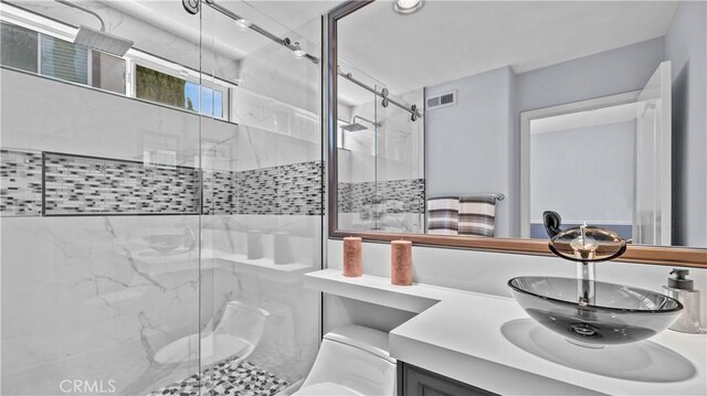 bathroom with vanity, toilet, and an enclosed shower