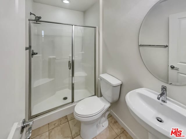 bathroom with walk in shower, tile patterned flooring, toilet, and sink