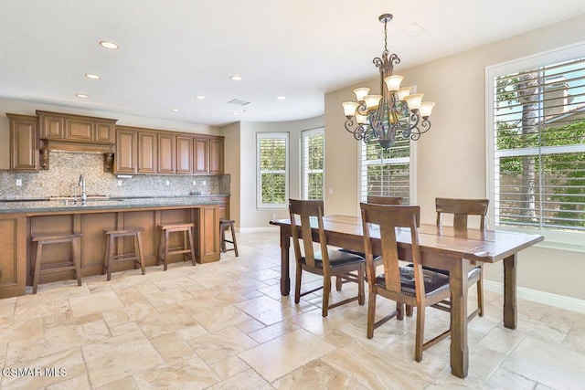 dining area featuring a notable chandelier and sink