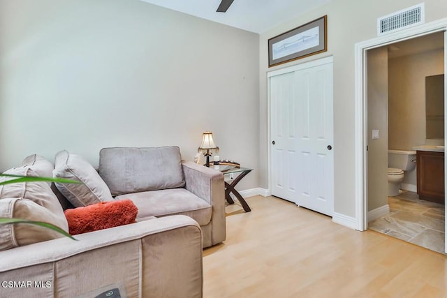 sitting room with ceiling fan and light hardwood / wood-style floors