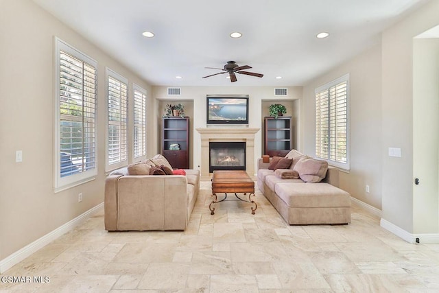 living room featuring a wealth of natural light and ceiling fan