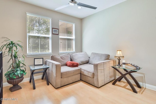 sitting room with ceiling fan and light hardwood / wood-style flooring