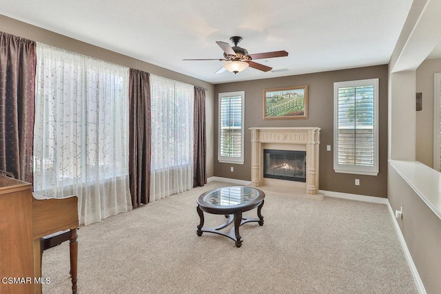 carpeted living room featuring ceiling fan and plenty of natural light