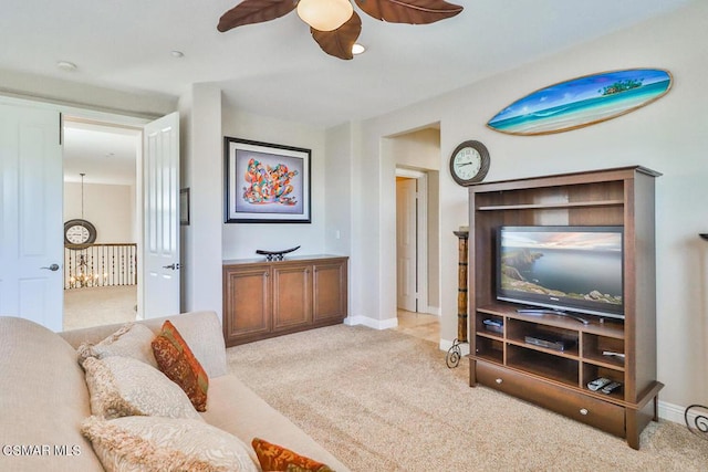 living room with light colored carpet and ceiling fan