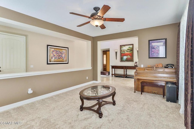 sitting room featuring light carpet and ceiling fan