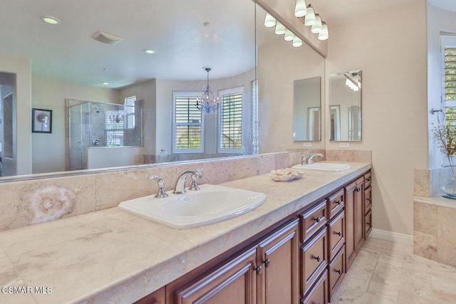 bathroom with vanity, an inviting chandelier, and walk in shower