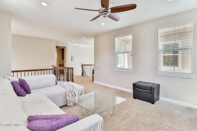 carpeted living room with ceiling fan