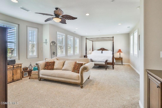 bedroom featuring light carpet and ceiling fan