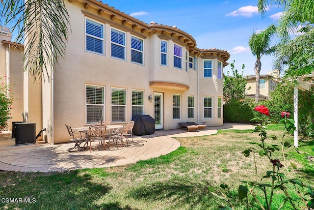 back of property with a patio area and central air condition unit