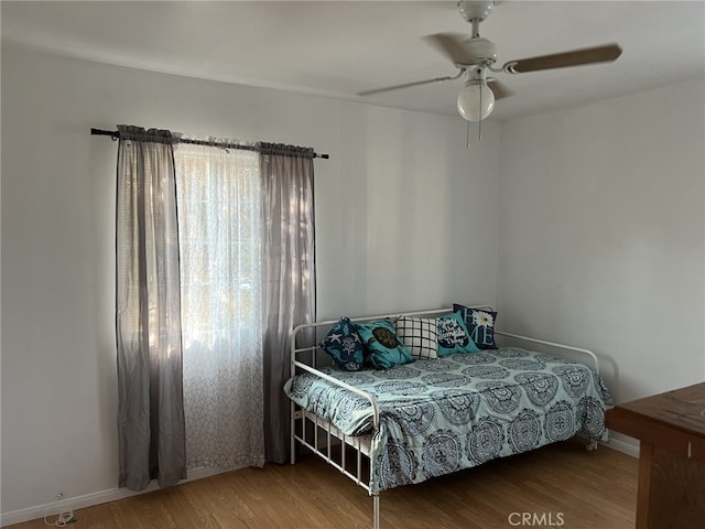 bedroom with hardwood / wood-style floors and ceiling fan