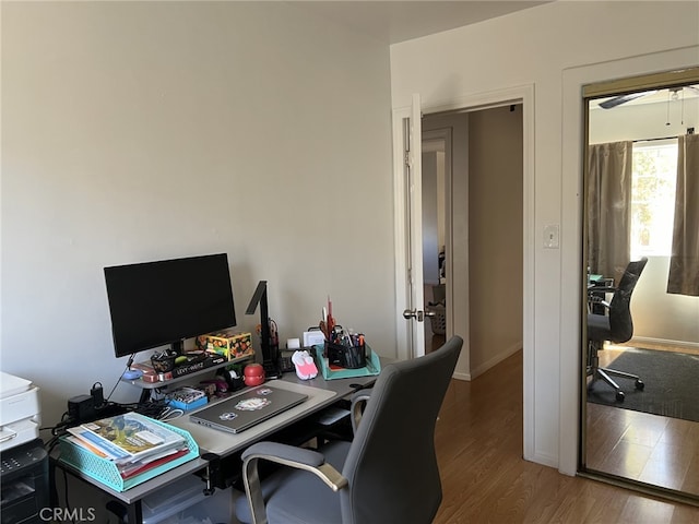 home office with hardwood / wood-style flooring