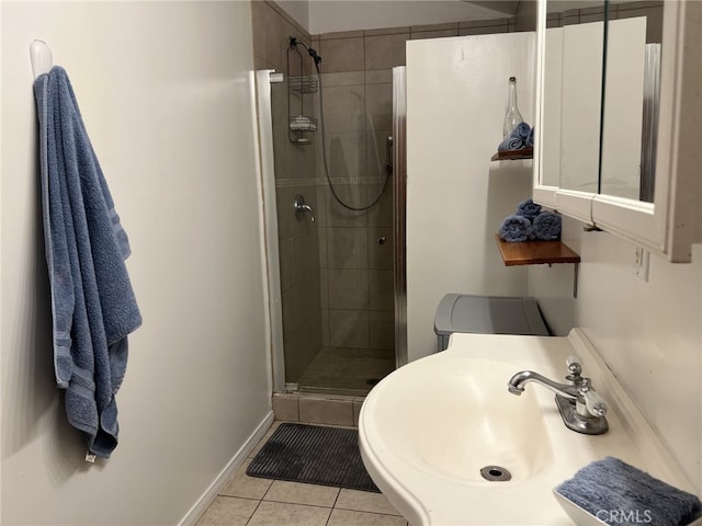 bathroom featuring sink, tile patterned flooring, and a shower with door