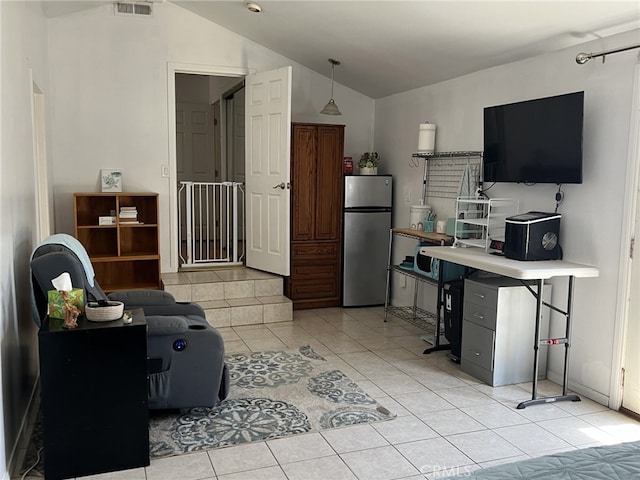 living room featuring lofted ceiling and light tile patterned floors