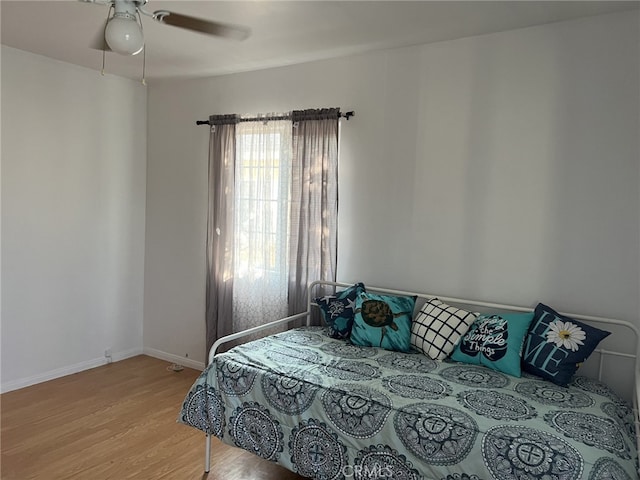 bedroom with light wood-type flooring and ceiling fan