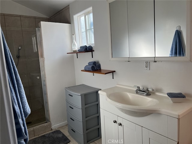 bathroom featuring lofted ceiling, vanity, tile patterned flooring, and an enclosed shower