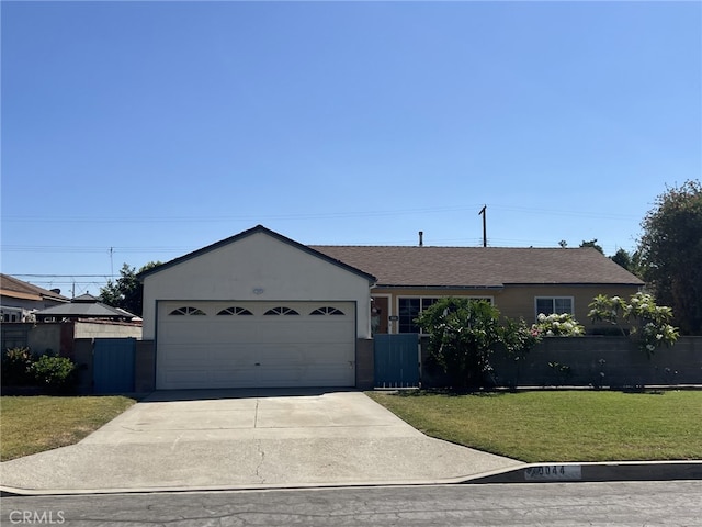 single story home featuring a front yard and a garage