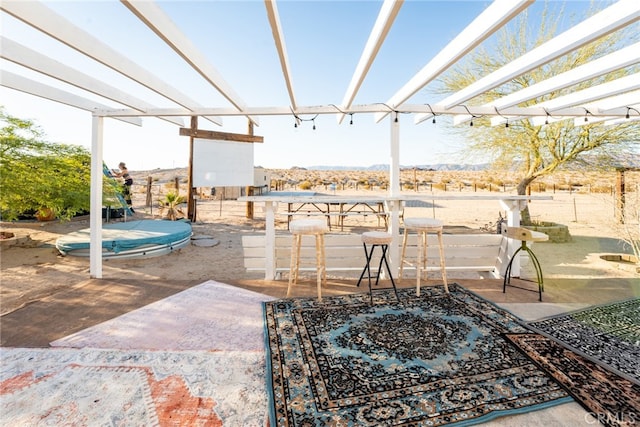 view of patio featuring a bar and a pergola