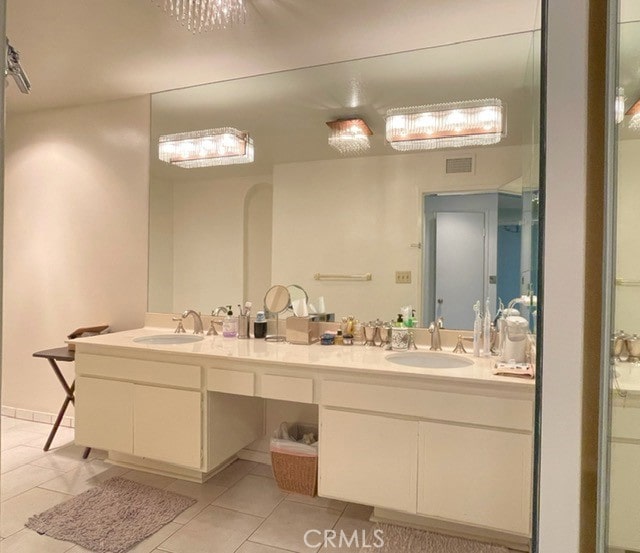 bathroom with tile patterned floors and vanity