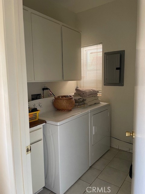 washroom with cabinets, washer and dryer, electric panel, and light tile patterned flooring