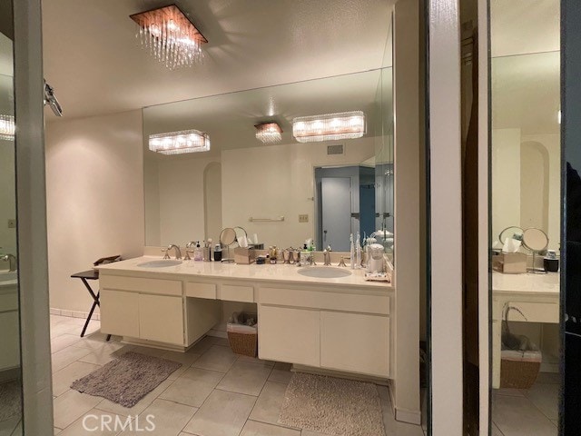 bathroom featuring tile patterned flooring and vanity