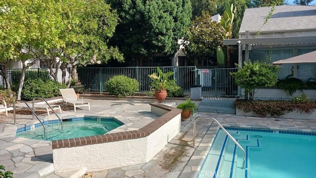 view of pool with a hot tub and a patio area