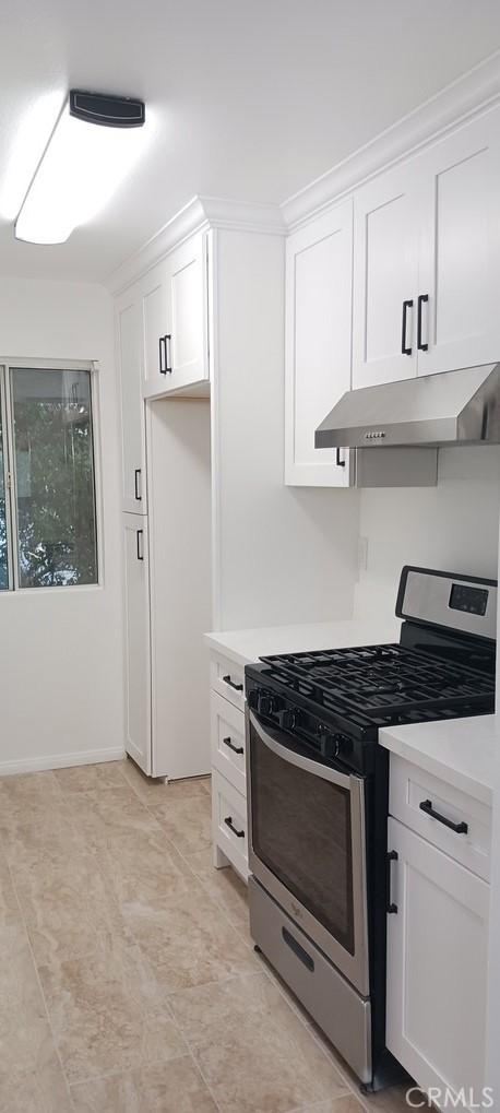 kitchen featuring white cabinetry and stainless steel range with gas cooktop