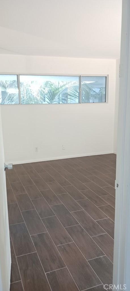 spare room with dark wood-type flooring