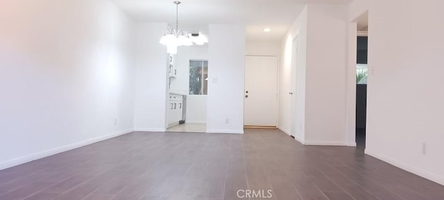 unfurnished room featuring dark hardwood / wood-style floors and a notable chandelier