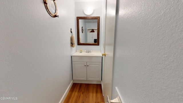 corridor featuring sink and light hardwood / wood-style floors