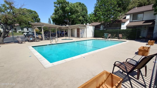 view of pool featuring a community hot tub and a patio