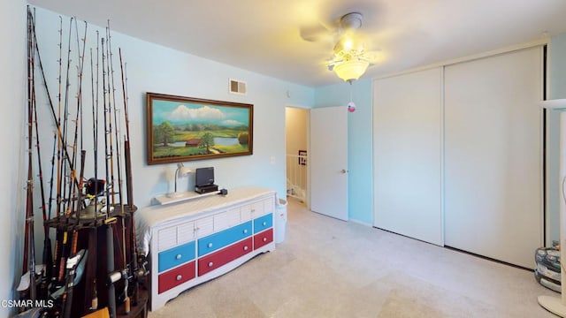 bedroom with light carpet and a closet