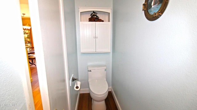 bathroom featuring hardwood / wood-style flooring and toilet