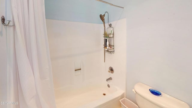 bathroom featuring toilet and shower / bathtub combination with curtain