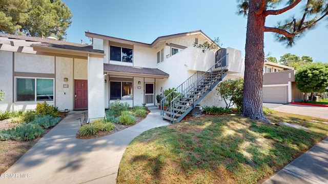 view of front of home featuring a porch and a garage