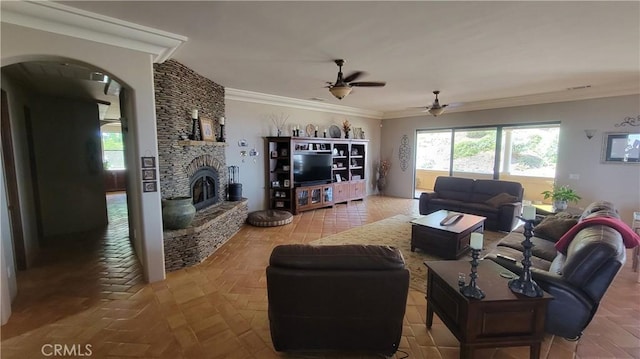 34135 Cameron Dr, Sage, CA 92544 - living room with a stone fireplace, arched walkways, ceiling fan, and crown molding