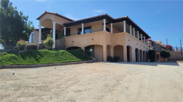 34135 Cameron Dr, Sage, CA 92544 - mediterranean / spanish-style house featuring fence, driveway, a balcony, and stucco siding