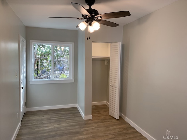 unfurnished bedroom featuring ceiling fan, a closet, and dark hardwood / wood-style floors