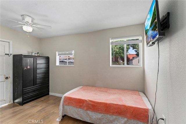 bedroom with ceiling fan and light hardwood / wood-style flooring